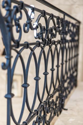 a row of black wrought iron fence at Karoso rezidencija in Klaipėda