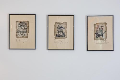 a group of framed drawings on a wall at Karoso rezidencija in Klaipėda