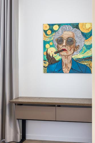 a painting of a woman smoking a cigarette at Karoso rezidencija in Klaipėda