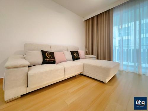 a white couch in a living room with a large window at KSL DAYA HOT SPRING BY JK HOME in Johor Bahru