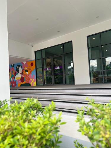a building with a painting on the side of it at Star Hotel Chiang Mai - SHA Extra Pus in Chiang Mai