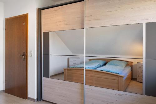a bedroom with a bed with a glass wall at Heidi's Panoramablick in Neuerode