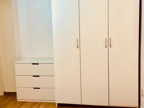 a white closet with white cabinets and a desk at La Casa di Francy B&B in Castellaneta