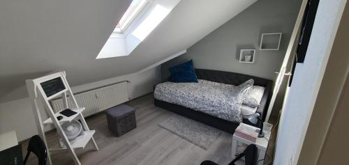 a small bedroom with a bed and a skylight at Auszeit in Wald-Michelbach