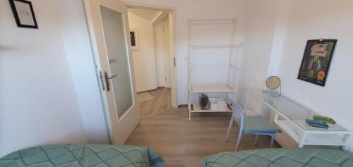 a room with a hallway with a desk and a chair at Auszeit in Wald-Michelbach