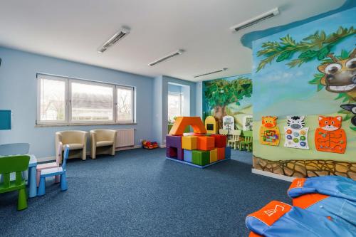 a childrens room with a childrens play area at Atrium Spa Practical Studio Near the Beach by Noclegi Renters in Sarbinowo