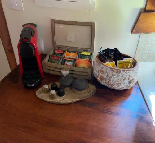 a table with a guitar and a box of items on it at BeLev Odem in Odem