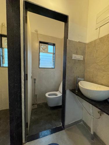 a bathroom with a white toilet and a sink at Cozy 1BHK Apartment - Casa Asud in Murūd