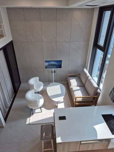 a living room with a couch and a table and chairs at Center of Seoul, Newly built high floor house with view in Seoul