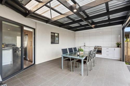 a dining room with a table and chairs in a kitchen at Paradise on Peninsula in Safety Beach