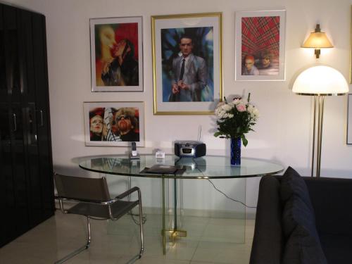 a table with a vase of flowers and pictures on the wall at Chalet Valley in Valley