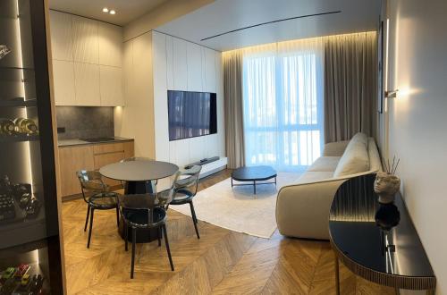 a living room with a couch and a table at Royal Class of the City centre-Adults Only in Chişinău