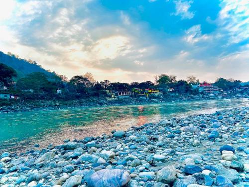 a large group of rocks next to a river at LA Riqueza Pride Inn # Rootop Swimming Pool with Mountain View # Free Parking # Tapovan # Center of Rishikesh# in Rishīkesh