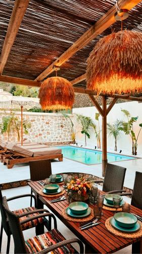 a table and chairs under an umbrella on a patio at City Compass Sunset Villa in Rhodes Town