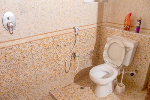 a bathroom with a toilet and a shower at A Peaceful Retreat in Nyali - 3BR With Pool in Mombasa