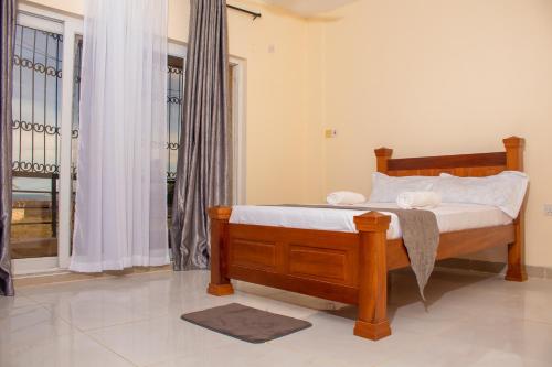 a bedroom with a bed with white sheets and a window at A Peaceful Retreat in Nyali - 3BR With Pool in Mombasa
