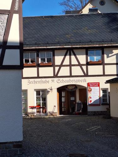 a building with a sign on the front of it at Ferienwohnung Rote-Villa in Marienberg