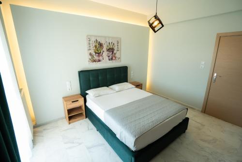 a bedroom with a bed with a green headboard at Meteora House with a view in Kalabaka