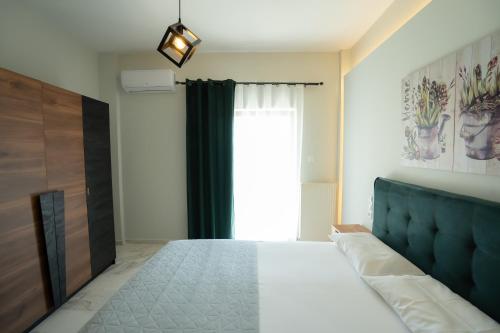 a bedroom with a bed and a window at Meteora House with a view in Kalabaka