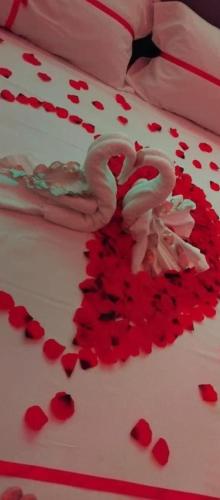 a white cake with red hearts on it at B&B GRECALE Suite & Spa in Rende