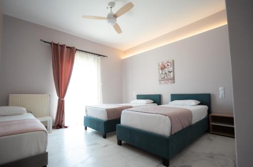 a bedroom with two beds and a window at Meteora House with a view in Kalabaka