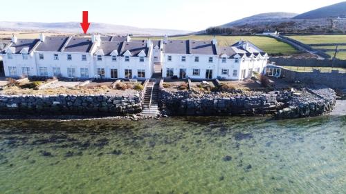 an aerial view of a house on an island in the water at Cozy Waterside Retreat Ballyvaughan 3 in Ballyvaughan