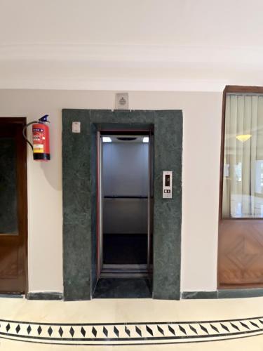 a hallway with a door in a building at Hotel Supreme Suites I B2B Friendly I Ludhiana in Ludhiana