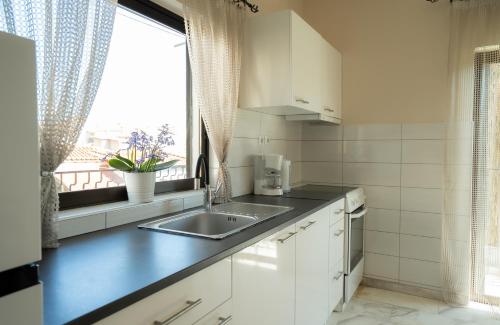 a kitchen with a sink and a window at Meteora House with a view in Kalabaka