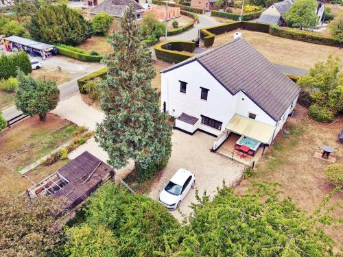 an aerial view of a white house with a car parked at Gîte du Volcan in Namur