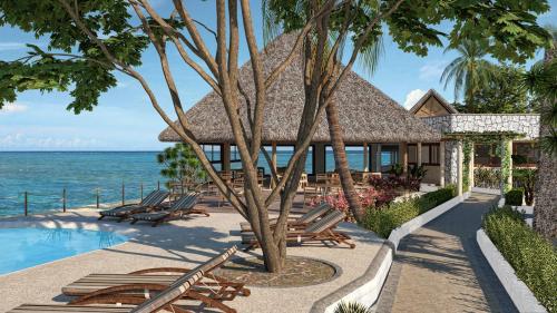 a resort with a pool and chairs and the ocean at Matemwe Attitude - Adults Only in Matemwe