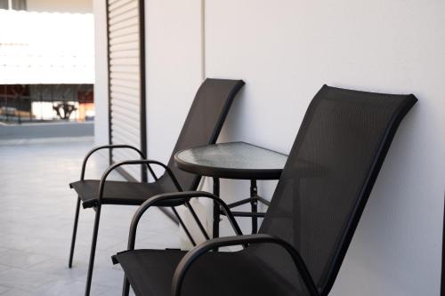 two black chairs and a table in a room at Meteora House with a view in Kalabaka