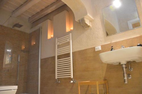 a bathroom with a sink and a ladder on the wall at Secret B&B in Trapani