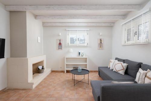 a living room with a couch and a fireplace at Eliathos Hillside Retreat in Archanes