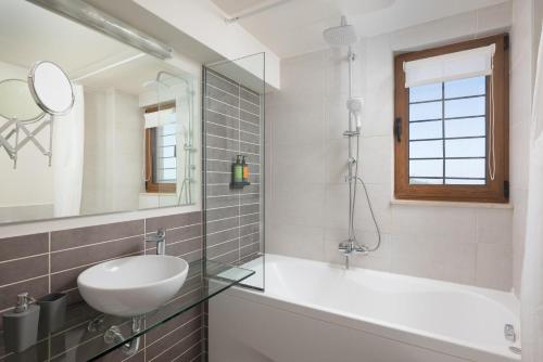 a bathroom with a sink and a mirror at Eliathos Hillside Retreat in Archanes