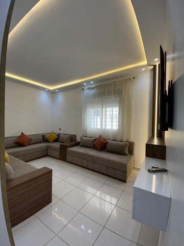 a living room with a couch and a window at Sable d'or in Tangier