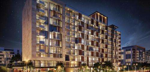 a rendering of a tall building at night at Roomook Apartments in Dubai