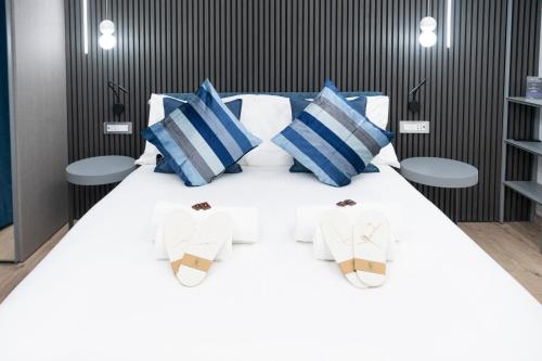 Ένα ή περισσότερα κρεβάτια σε δωμάτιο στο Teulada Luxury Rooms