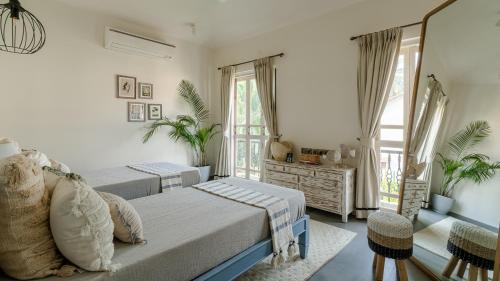 a bedroom with two beds and a window at LohonoStays Beleza Villa A in Marna