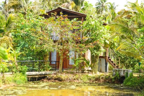 a house in the middle of a body of water at Steps Garden Resort in Negombo