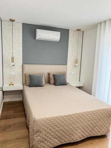a bedroom with a large bed with blue walls at Casinha in Celorico de Basto