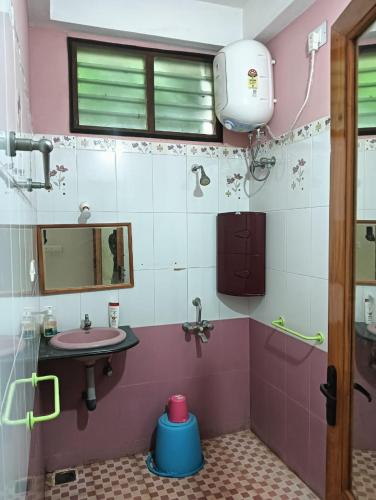 a bathroom with a sink and a mirror at Helios Villa in Auroville