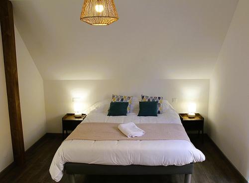 a bedroom with a large bed with two night stands at L'évasion verte in Colroy-la-Roche