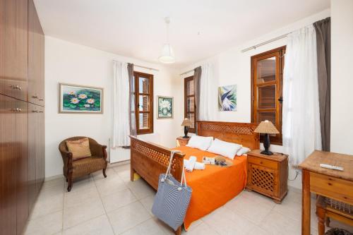 a bedroom with a bed and a desk in it at Villa Irene Palace in Paphos