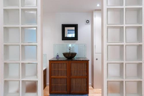 a room with two glass doors and a wooden cabinet at Churchlands in Kirdford
