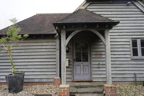 a house with a door and an entry way at Churchlands in Kirdford