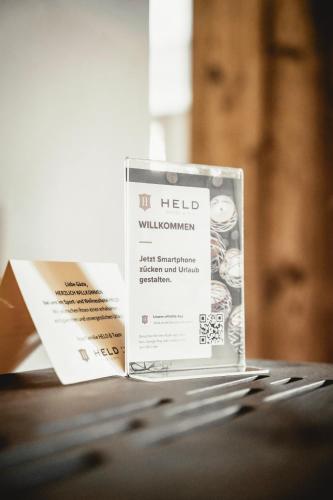 a book sitting on top of a table at HELD - Hotel & Spa , 4 Sterne Superior, Zillertal in Fügen
