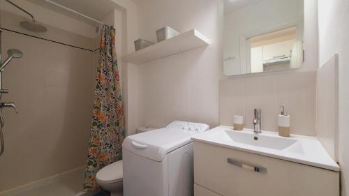 une salle de bain blanche avec des toilettes et un lavabo dans l'établissement Studio cosy pour 2 Climatisation au Point Zéro - ROSSIconciergerie - Linge inclus, à La Grande Motte