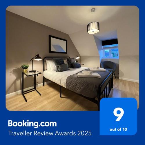 a bedroom with a bed and a table with a lamp at Telford Townhouse with Parking and Garden in Telford