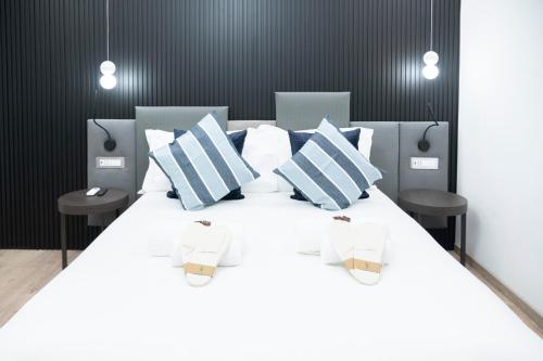 Ένα ή περισσότερα κρεβάτια σε δωμάτιο στο Teulada Luxury Rooms