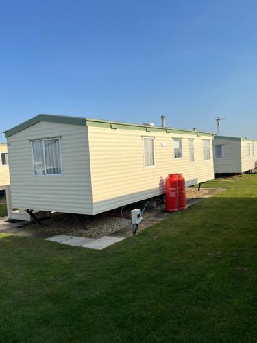 a yellow and gray trailer parked in a yard at The chase ingoldmells in Addlethorpe